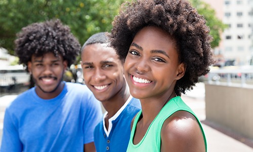 three teenagers smiling